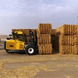 Forklift working with hay bales