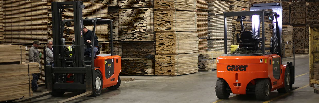 Two electric forklifts working in a warehouse