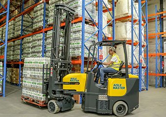 Worker using and electric Aisle Master forklift