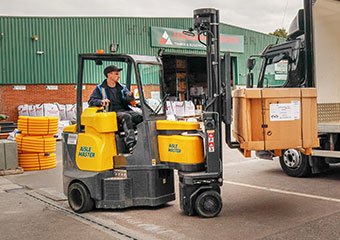 Worker using an Aisle Master forklift in a yard