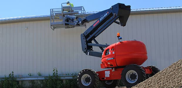 Man using Manitou boom lift on a construction site