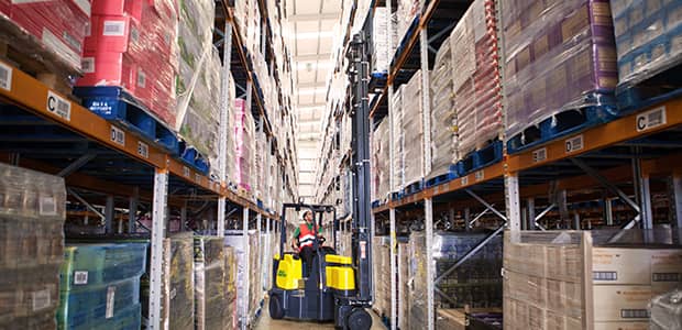 Narrow aisle forklift working in a warehouse after getting parts replaced