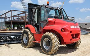 Manitou rough terrain forklift rental used on a construction site