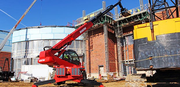 Rental of a Manitou rotating telehandler working construction
