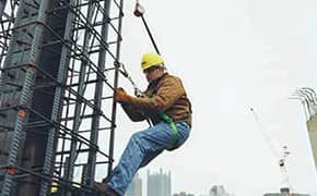 Worker wearing a safety harness for fall protection