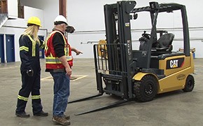Leavitt Machinery workers doing a safety check on a forklift