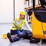 Worker helping a coworker who has been in a forklift accident