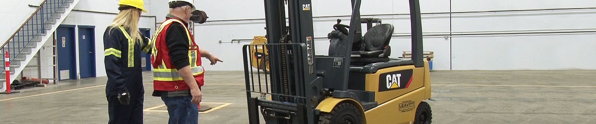 Workers doing operator training on a counterbalanced forklift