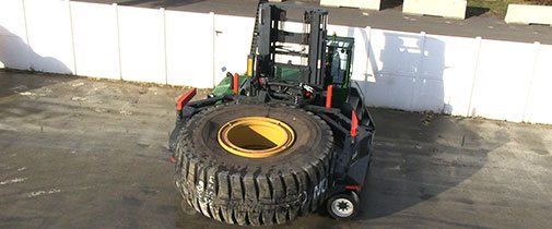 Combilift side loader used to haul a mining truck tire