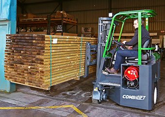 Combilift multi-directional forklift hauling lumber