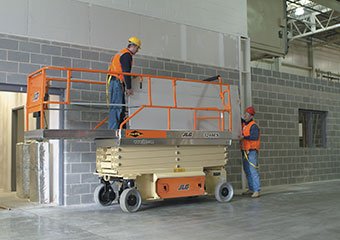 Workers using an electric JLG scissor lift