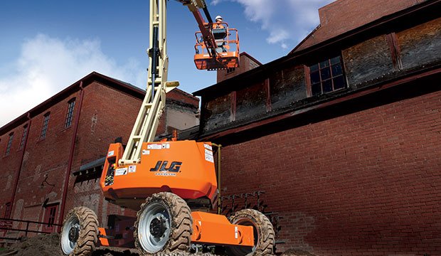 Rented JLG Leavitt boom lift working construction