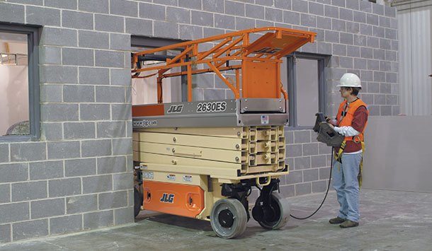 Rental of an electric scissor lift being driven though a doorway