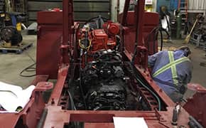 Heavy duty equipment mechanic rebuilding the engine