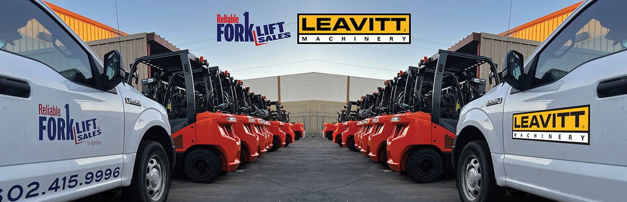 Reliable Forklift Sales truck and Leavitt Machinery truck in front of forklifts