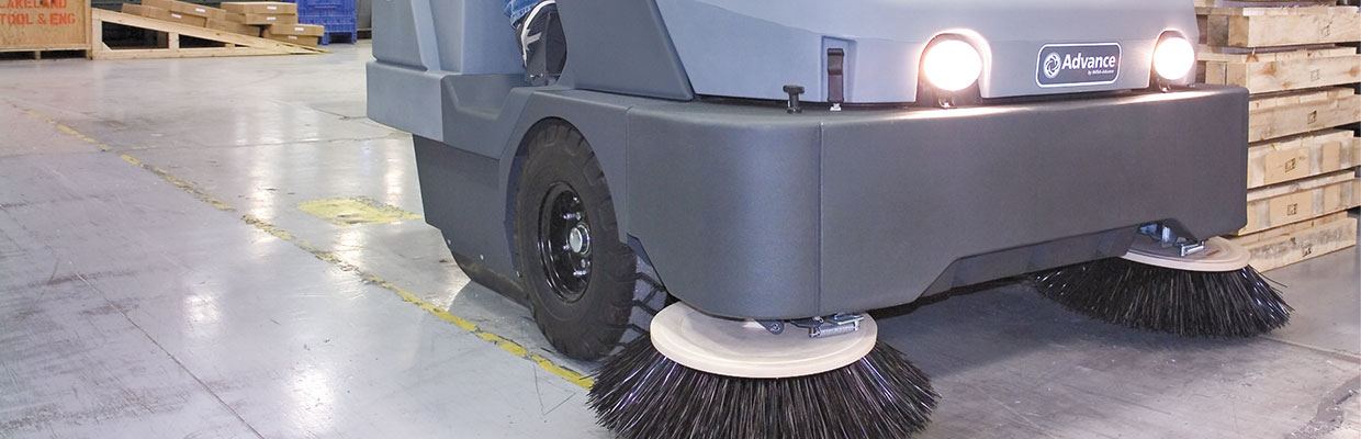 Sweeper cleaning the inside of a warehouse