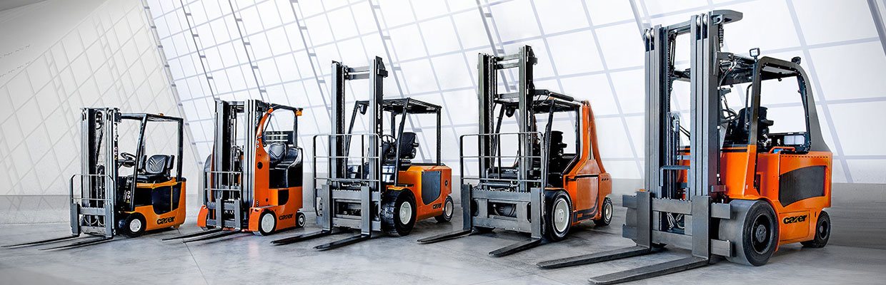 Five Carer Electric Forklifts in front of a window