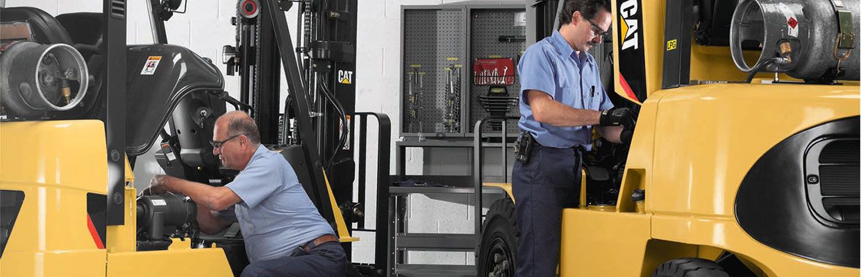 Two forklifts being rebuilt