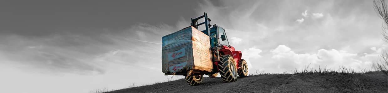 Machine operator driving outdoor forklift during the fall season