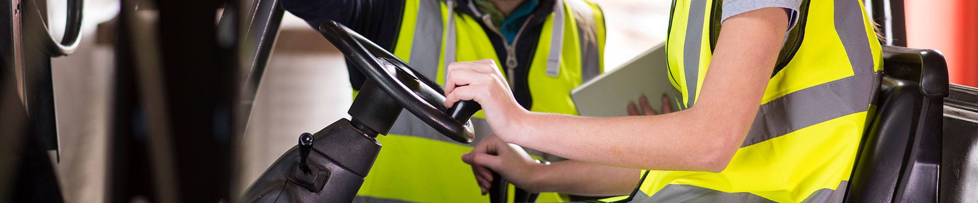 Man and lady doing forklift certificate training