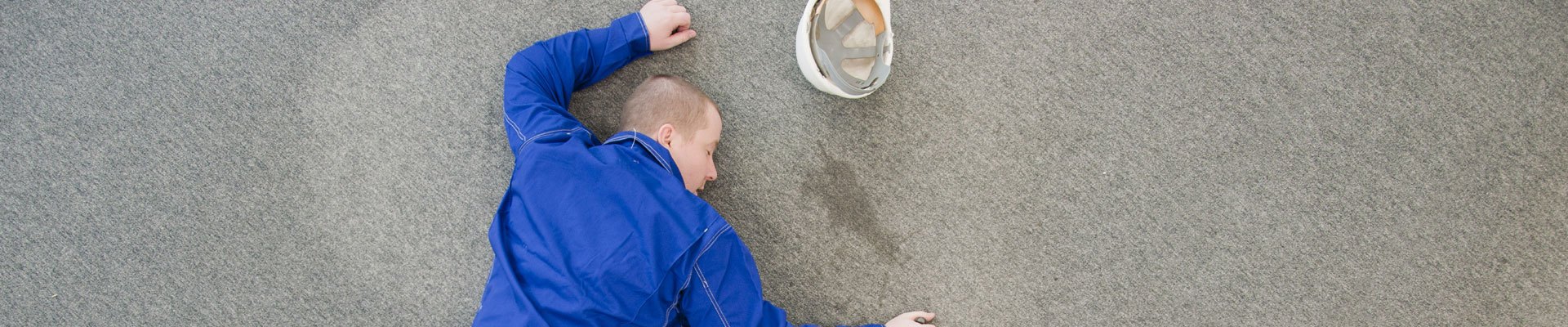 Man slips, trips and falls on the cement at a worksite