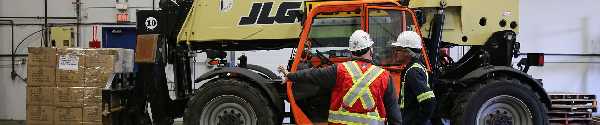 Two men training on a telehandler