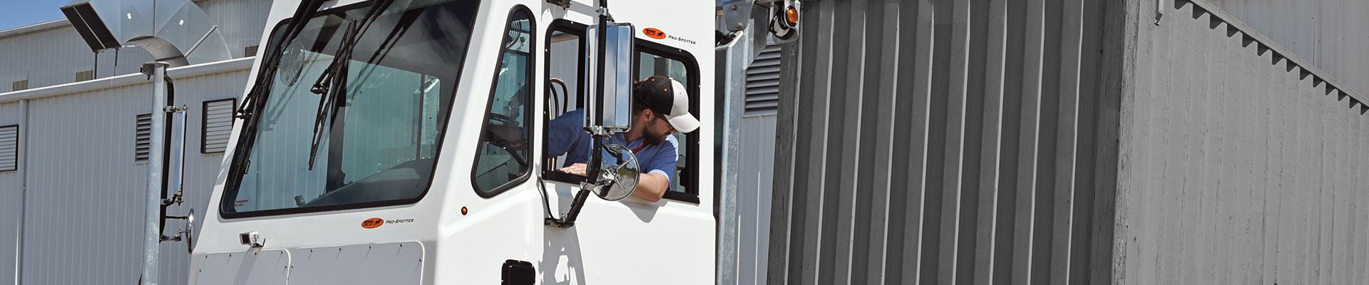 Man backing up a trailer into a loading dock