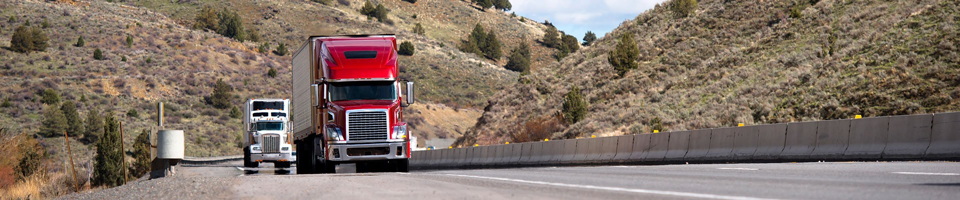 Commercial haul trucks driving down the road