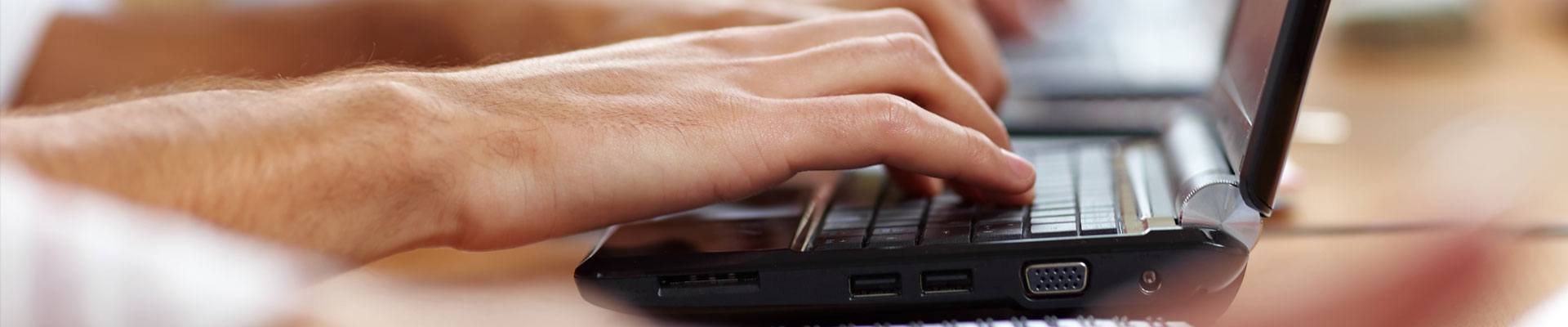 Person working on a computer doing learning management training