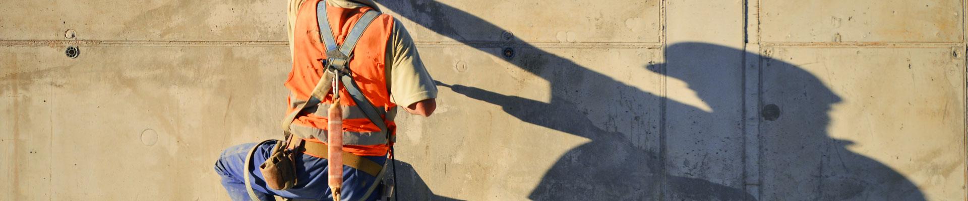 Worker practicing fall protection safety on a worksite