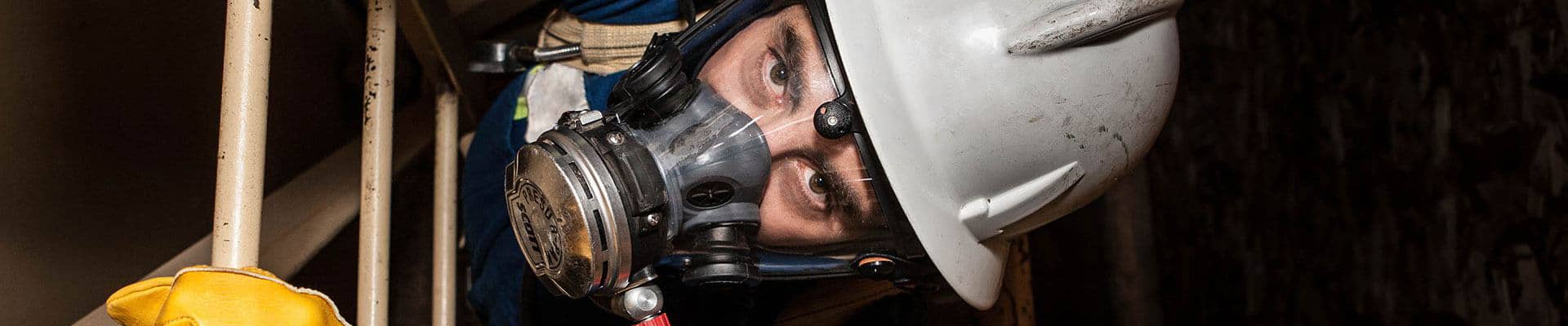 Operator climbing a ladder in a confined space