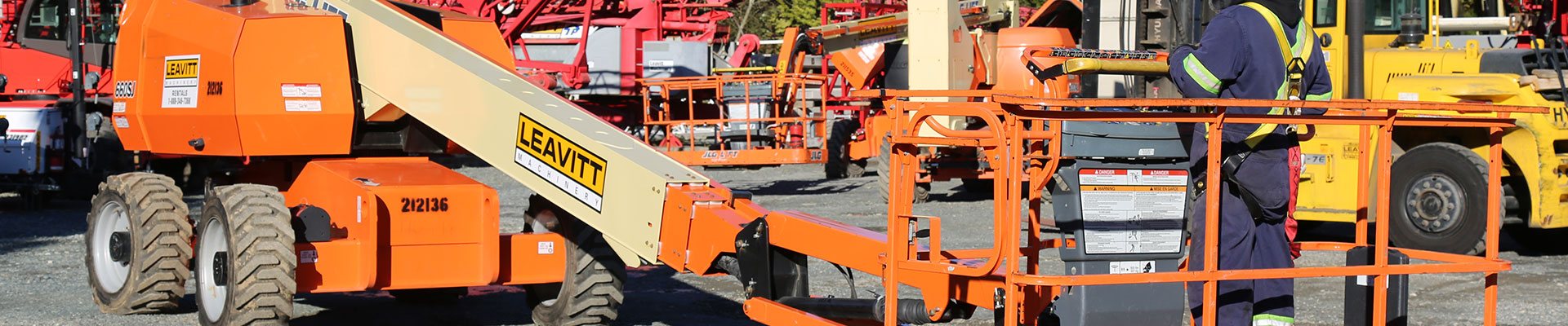 Worker on a boom lift equipment practicing fall protection safety