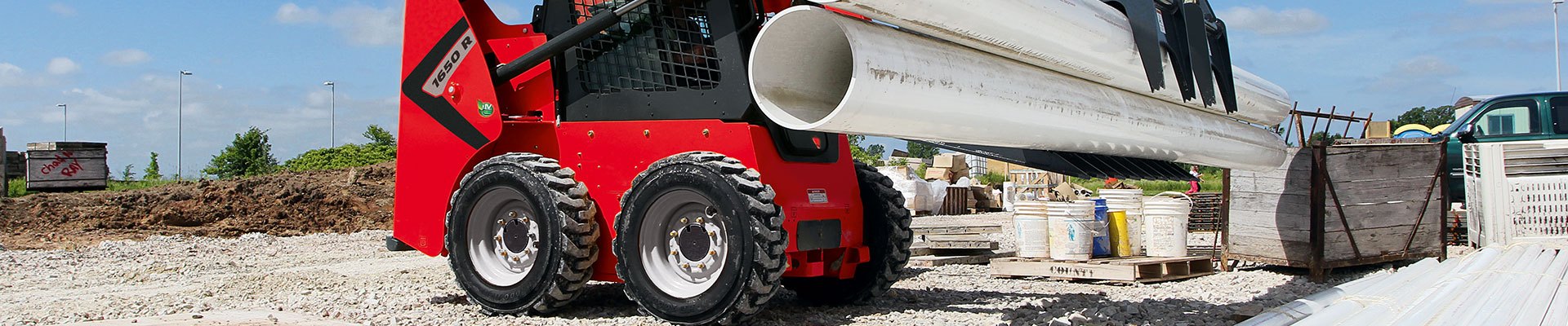 Operator training on a skid steer in a yard