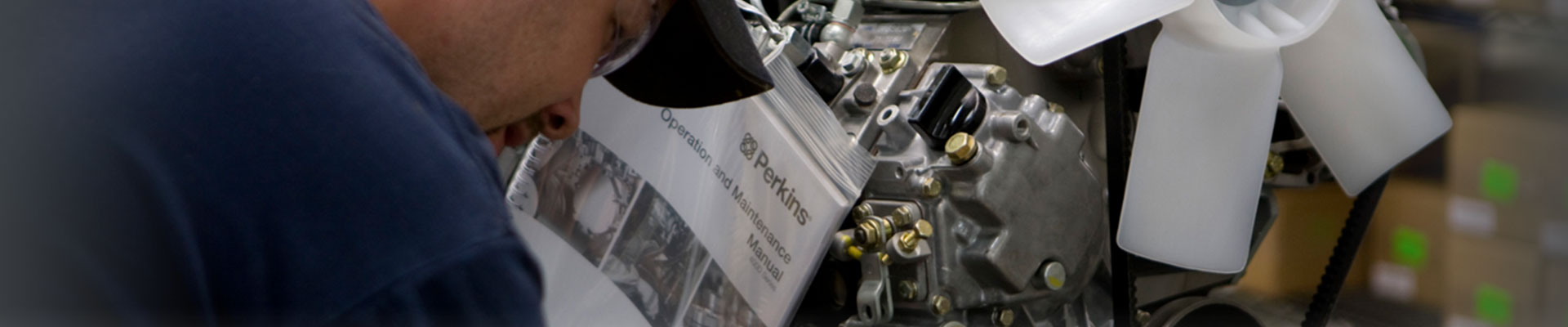 Man working with OEM parts for a Perkins engine