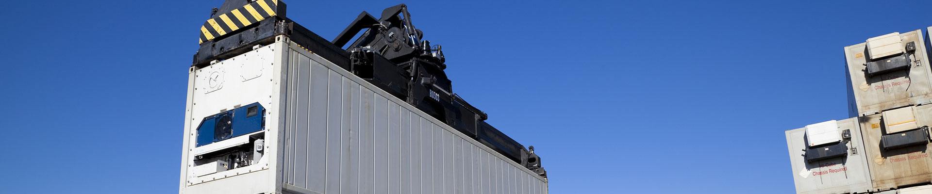 Terex reach stacker with a container of parts