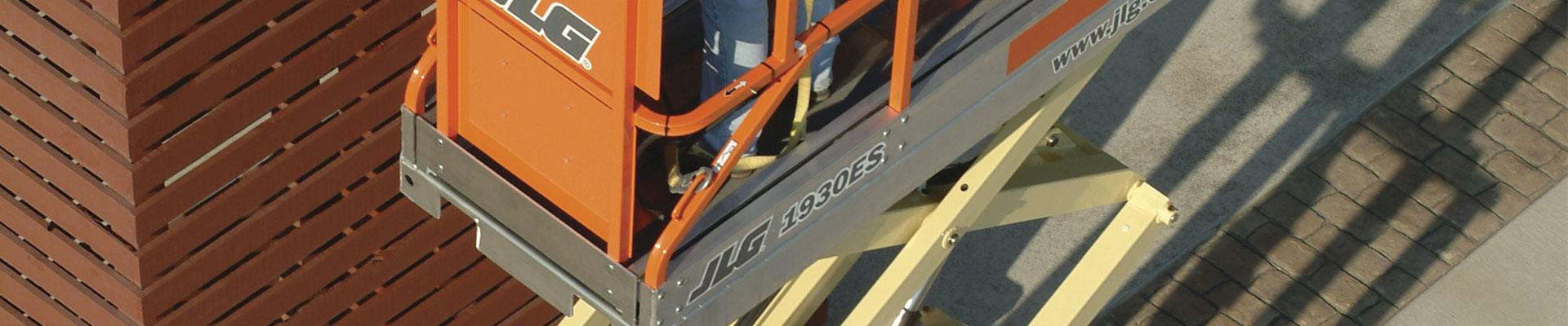 Scissor lift with replaced parts working on a construction site