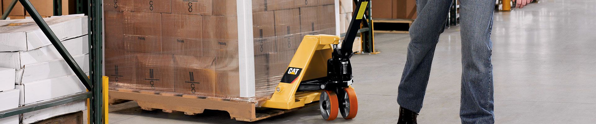 Manual pallet jack being used in a warehouse