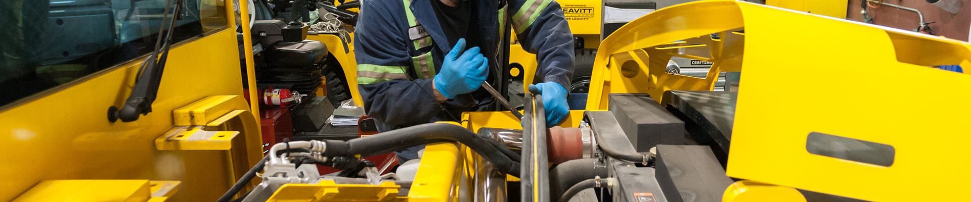 In-shop technician servicing a forklift