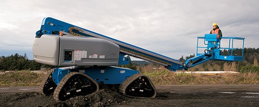 Genie boom lift driving in dirt