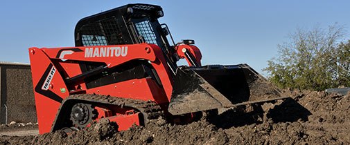 Manitou skid steer moving  dirt