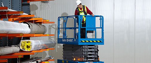 Genie scissor lift driving in a warehouse