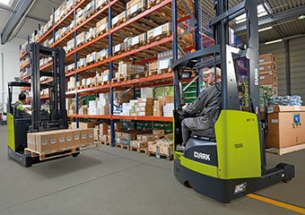 Clark narrow aisle forklifts being used in a warehouse