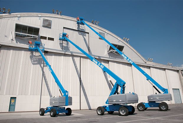 Three Genie boom lift on an industrial site