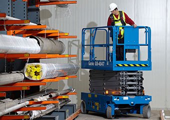 Worker using a Genie scissor lift