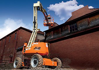 Worker using a JLG boom lift