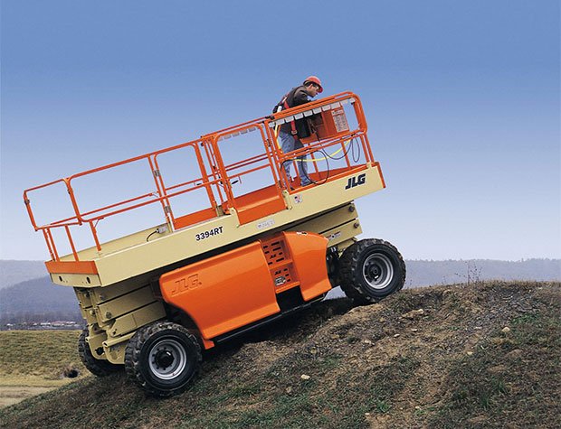 JLG scissor lift going up a hill