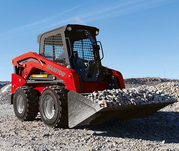 Manitou skid loader hauling gravel