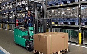 3 Wheeled Mitsubishi electric forklift working in a warehouse