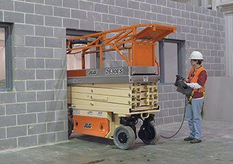 JLG aerial lift driving through a doorway