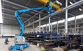 Electric boom lift being used in a factory